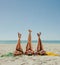 Woman in bikini sunbathing on beach with legs raised to the sky