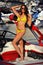 Woman in bikini and sunglasses posing pretty on motor speed-boat