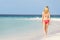 Woman In Bikini Walking On Beautiful Tropical Beach