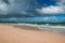 Woman in bikini walks on beach in Cabarete Beach, Dominican Republic