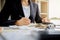 Woman with bills and calculator. Woman using calculator to calculate bills at the table in office. Calculation of costs.