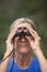 Woman with binoculars in nature outdoor