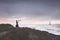 Woman with binoculars observes the infinite ocean , concept of freedom and travel