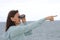 Woman with binoculars at seaside