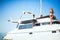 Woman with binoculars standing on a big white yacht in the sea