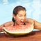 Woman biting in melon in summer