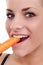 Woman biting raw carrot