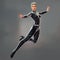 Woman in Black Bodysuit Floating in the Air with Arms Outstretched