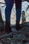 Woman with black Boots and blue jeans going up stairs rocks