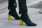 Woman with black boots and yellow heels before Giorgio Armani fashion show, Milan Fashion Week street style