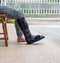 woman with black cast on leg sitting on wood chair, body injury