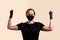 Woman in black dress face mask and gloves raised her hands with fists and looking at camera