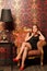 Woman in black dress sitting on vintage chair