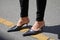 Woman with black leather pointed shoes and black trousers before Etro fashion show, Milan Fashion