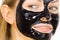 Woman with black peel off mask on face