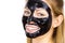 Woman with black peel off mask on face