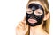 Woman with black peel off mask on face