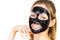 Woman with black peel off mask on face