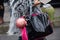 Woman with black and pink polished Armani Jeans bag before Diesel Black Gold fashion show, Milan Fashion Week