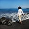 Woman on black sand beach