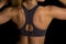 Woman in black sports bra back close arms up
