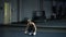 Woman in black sportswear doing burpees exercise in a gym