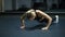 Woman in black sportswear doing burpees exercise in a gym