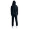 Woman in black tracksuit hood standing