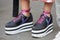 Woman with black and white wedge heels shoes with pink shoelaces before Salvatore Ferragamo fashion show,