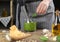 Woman blending pesto sauce in bowl at table