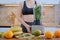 Woman blending spinach, bananas and almond milk to make a healthy green smoothie