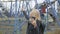 A woman blogger in a deserted abandoned amusement park with a smartphone talking on video chat.