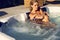 woman with blond hair relaxing in outdoor whirlpool