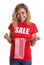 Woman with blond hair in a sales-shirt holding a shopping bag