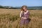 Woman blonde farmer on field of ripe wheat