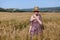 Woman blonde farmer on field of ripe wheat