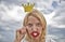 Woman blonde hair hold cardboard tiara or crown and red lips symbol of love sky background. Lady princess posing