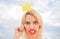 Woman blonde hair hold cardboard tiara or crown and red lips symbol of love sky background. Lady princess posing