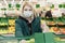 Woman blonde in a medical mask chooses vegetables in a supermarket. Self-isolation in a pandemic