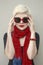 Woman blonde in red scarf, sunglasses. Fashion haircut, accessories.