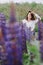 woman at blooming lupines field