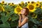 Woman on blooming sunflower field