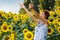 Woman on blooming sunflower field