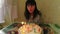 Woman blow out candles on birthday cake, happy birthday concept