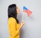 Woman blowing on american flag