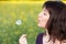 Woman blowing dandelion