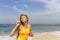 Woman blowing soap bubbles at the beach
