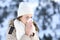 Woman blowing in a tissue in a cold snowy winter