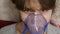 Woman in a blue hospital mask. Inhale vapors from the respiratory tract into the lungs. Cough treatment. A sick girl in