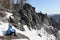 Woman in a blue jacket, sitting on a mountainside, Altai, Russia